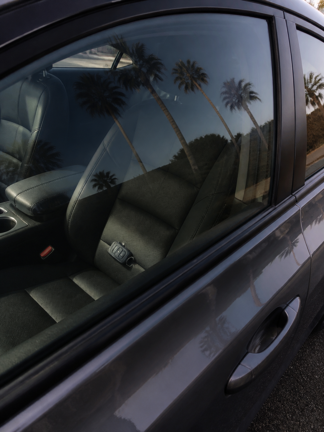 Car key fob locked inside a vehicle with closed windows.